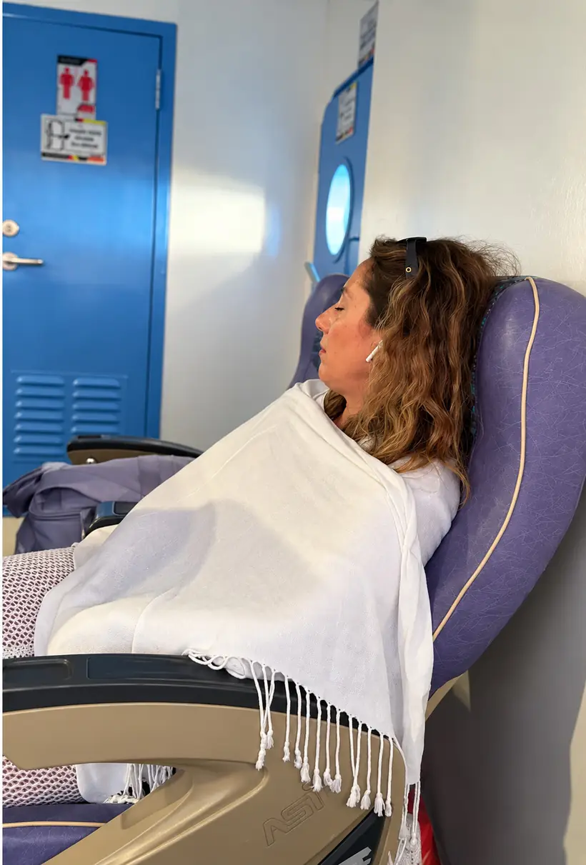 Cristina dormida en su asiento, tapada con un pareo, durante la travesía